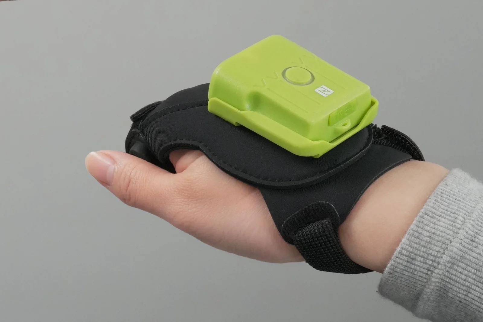Real-world view of the Richvoice OSG intelligent glove worn with the scan outlet facing the fingers